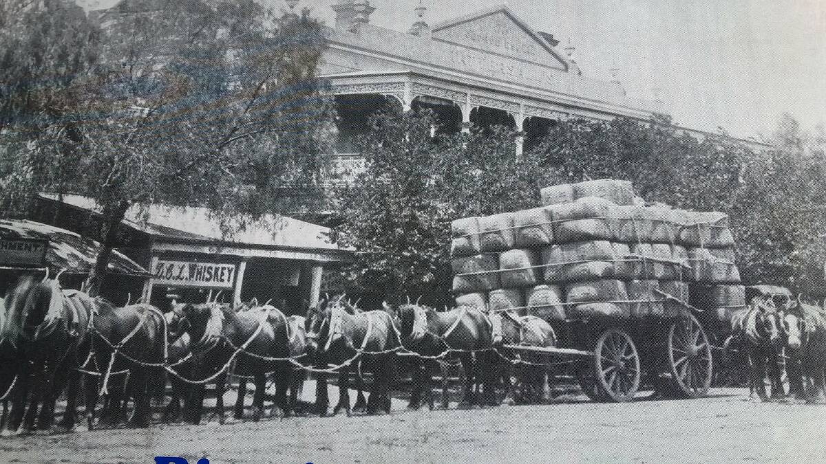 MAKING HAY: There were about 65 bales of wool on this load, with a dozen horses to pull it, when the photo was taken in front of a hotel in Hay.
