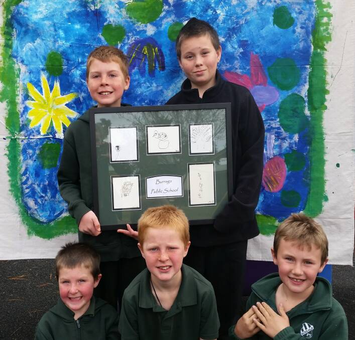 CREATIVE: Proud students from Burraga Public School display their entries.
