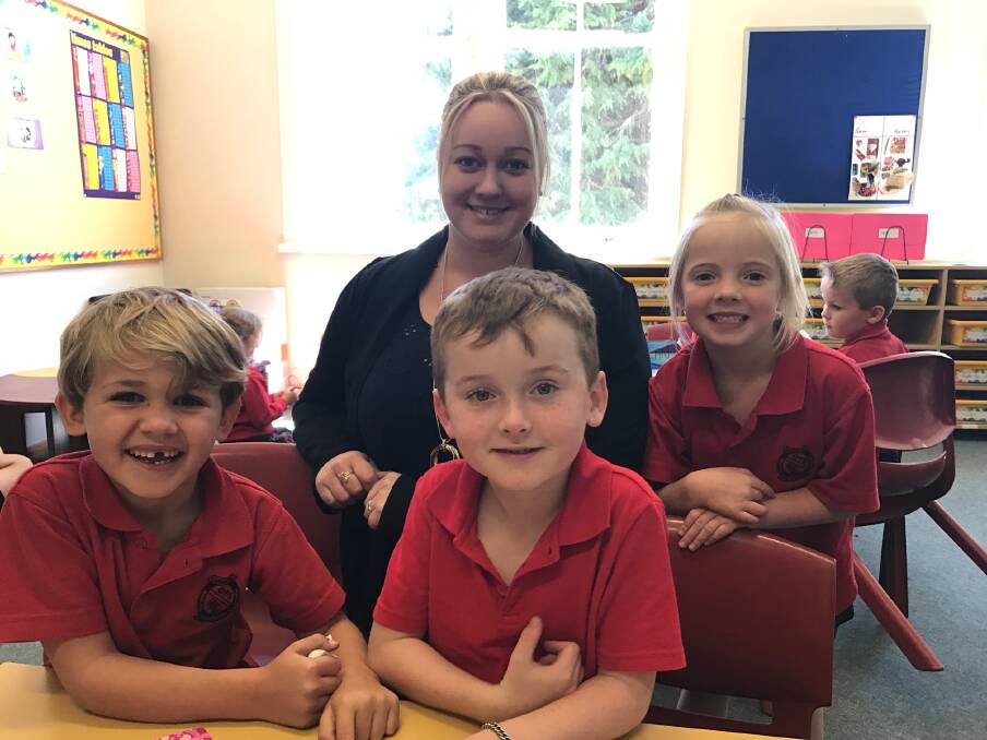 NEW FACE: New teacher Emma Swannell with three of her students, Jimmy Ryan, Kaiden Stapleton and Anna Rabbits.