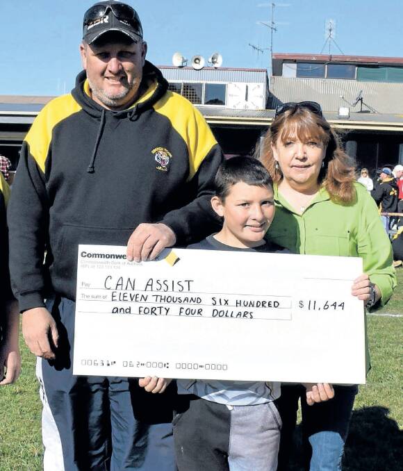 BIG BOOST: Oberon Junior Rugby League president Rowan Stock and junior league player Ben Stanton presented a cheque for $11,644 to Oberon Can Assist president Brenda Armstrong last year.