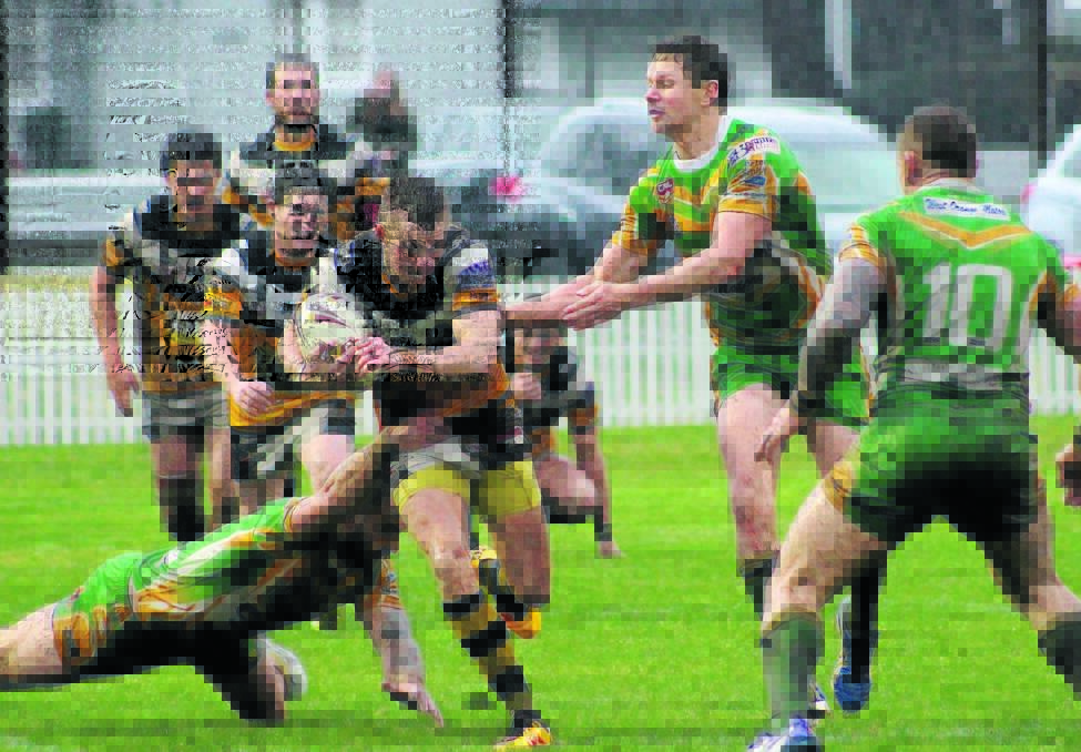 BRAVE: Tiger Tyler Hughes on the attack in slippery conditions at Wade Park on Sunday. Photo: Jess Ryan