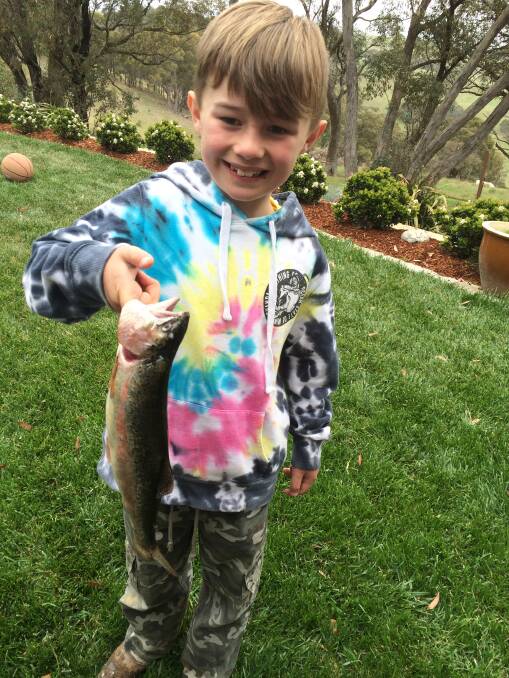 HAPPY: After a couple of hours fishing in Lake Oberon, Archie Graham managed to reel in a rainbow trout.