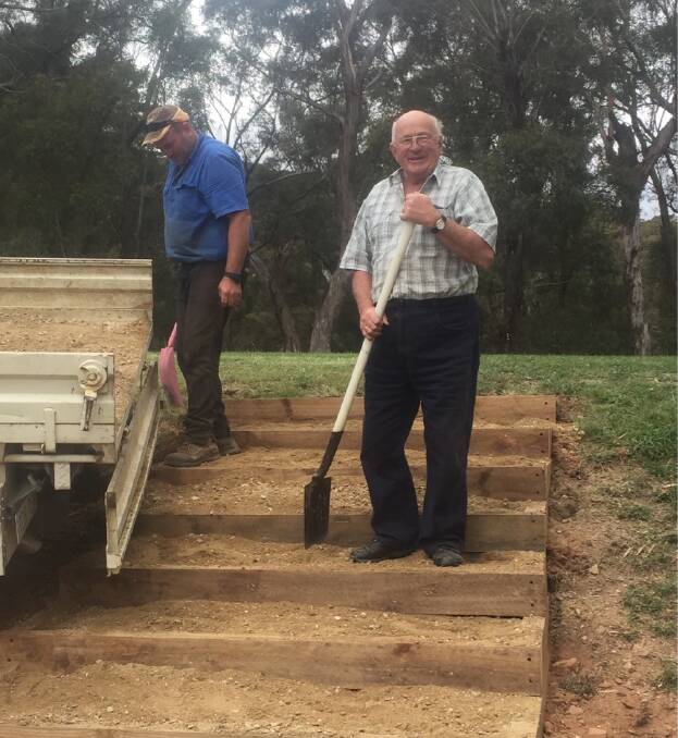 HAPPY TO HELP: Rob McGrath and Anthony McGrath working on the new steps on the eighth tee at Oberon golf course.