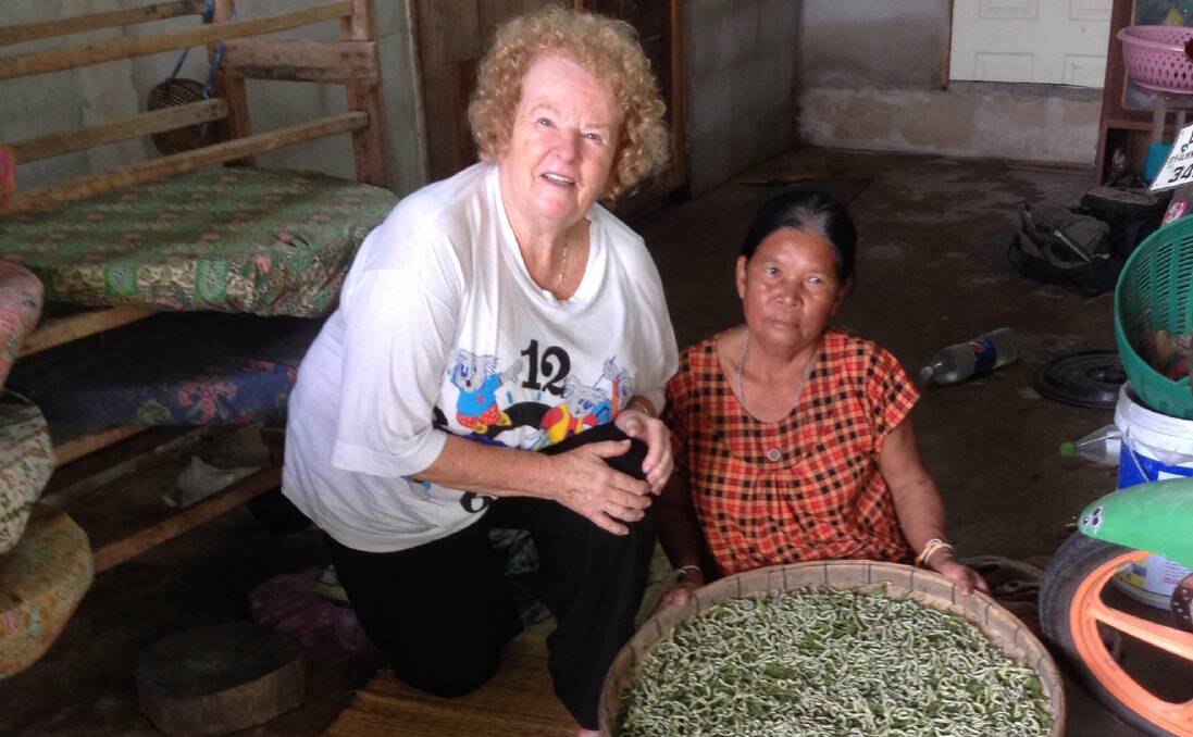 THE WORMS TURN: Kay Jones with Aet, a lady who lives in Wungdod Village and grows silk worms. The worms are kept in large baskets that are covered in mulberry leaves.