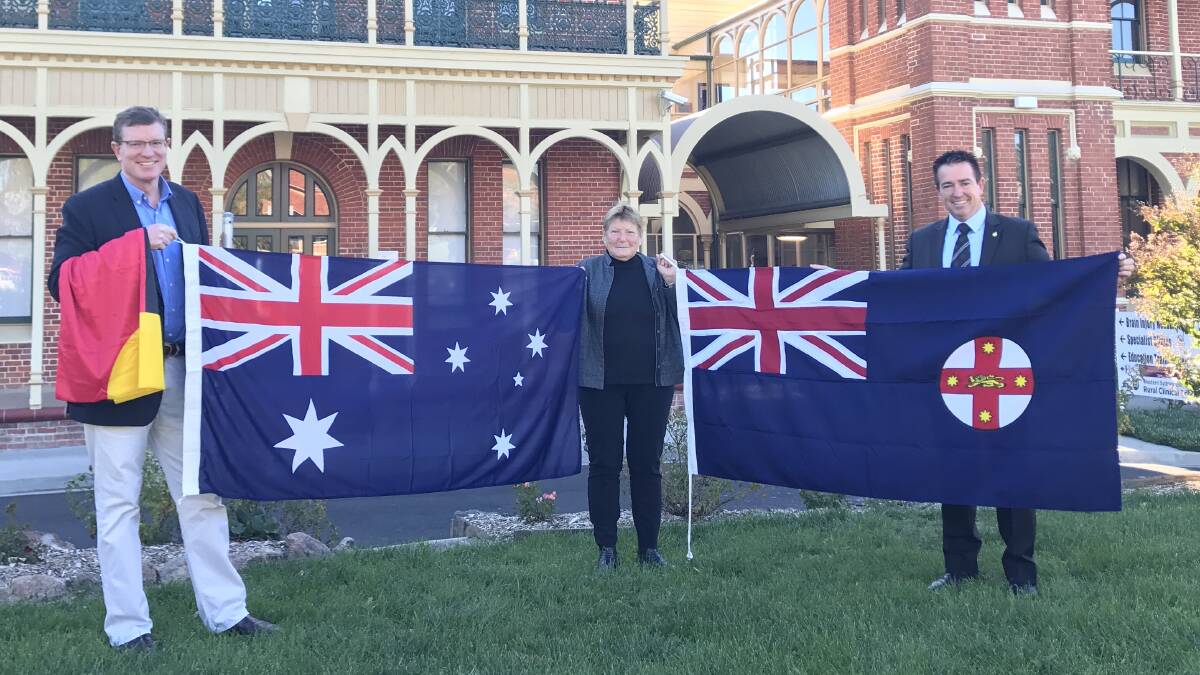 NATIONAL SPIRIT: Member for Calare Andrew Gee, Bathurst Hospital general manager Sue Patterson and Member for Bathurst Paul Toole at the flag presentation.