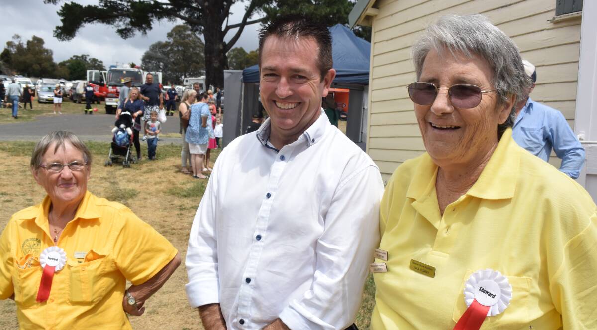 SMILES: Oberon Show Auxiliary members Marj Whalan and Gail Conley with Member for Bathurst Paul Toole.