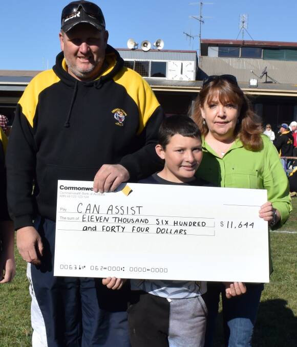 BIG BOOST: Oberon Junior Rugby League president Rowan Stock and junior league player Ben Stanton present a cheque for $11,644 to Oberon Can Assist president Brenda Armstrong.