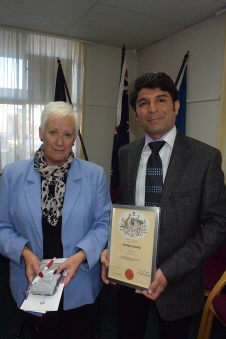 NEW CITIZEN: Mayor Kathy Sajowitz presents Adrian Rastad with his Australian Citizenship certificate.