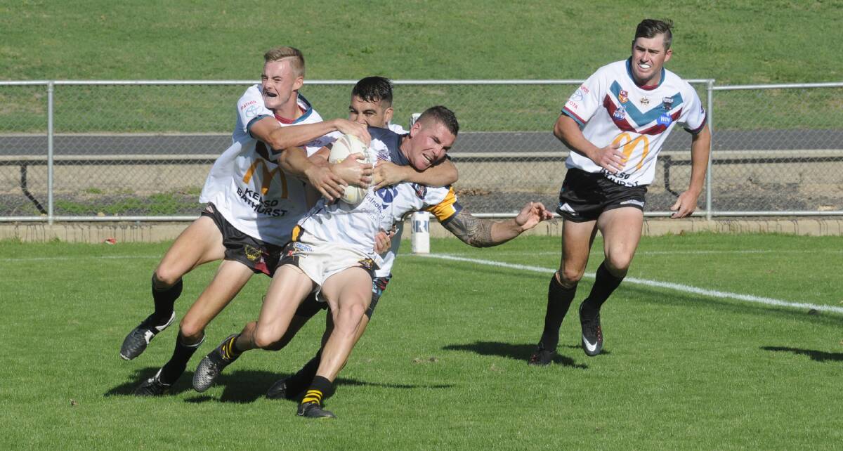 COME HERE: Oberon Tigers' Matt Ballinger is swamped by Bathurst Panthers players in the Bathurst Panthers Knockout grand final on Sunday.