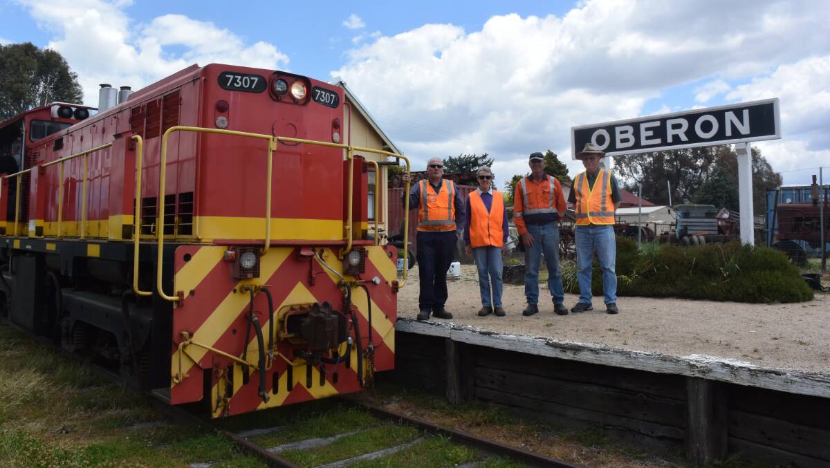 ON TRACK: Oberon Tarana Heritage Railway members Greg Bourne, Elaine Boxer, Graham Williams and John Brotchie moving the two locos under cover.