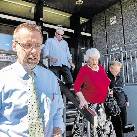 Cycling Tasmania executive officer Collin Burns outside the Launceston Magistrates Court yesterday with family and supporters of killed cyclist Lewis Hendey in the background. Picture: NEIL RICHARDSON