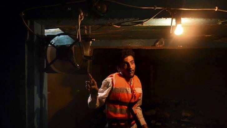 Mohamed, 25, of Pakistan, in the hull of the wooden fishing boat that he shared with the 52 people who died.  Photo: Kate Geraghty