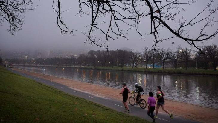 Joggers on a chilly morning run in what some might call a pea-souper. Photo: Eddie Jim