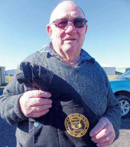 SUPPORT: Keen rugby league supporter and former Oberon Tigers player John Brien
holding one of the original Clayton Cup jackets, which was presented to each Oberon
player from NSW Country League in 1964.