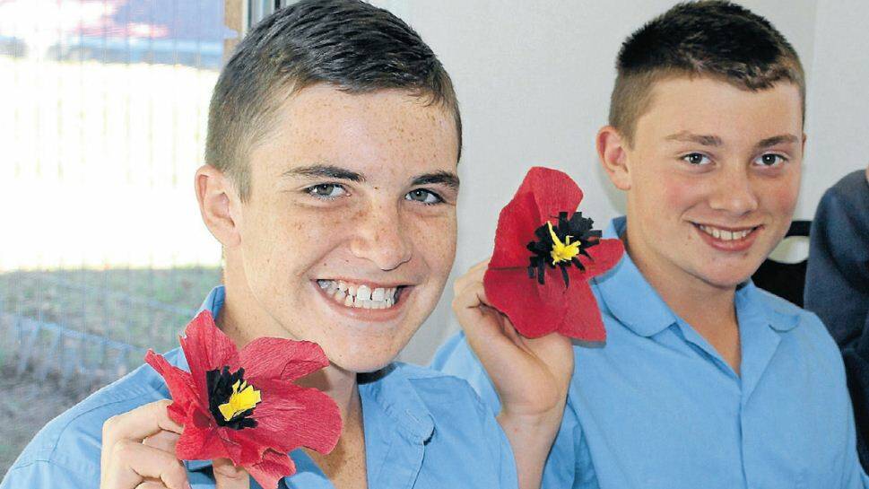 BLOOMING: Tyson Rice and Joshua Crye from St Joseph’s School enjoyed the community involvement when they became part of the Oberon poppy project on February 17. Students made a variety of poppies which will be displayed throughout the year to commemorate the 100th anniversary of the ANZAC tradition. 