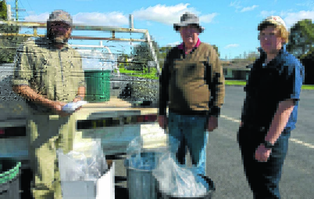 FRYING TIME: Peter Byrom, Oberon Central Acclimatisation Society branch president Kevin McGrath and Kevin’s grandson Dylan ready to release trout fry into the district’s waterways.