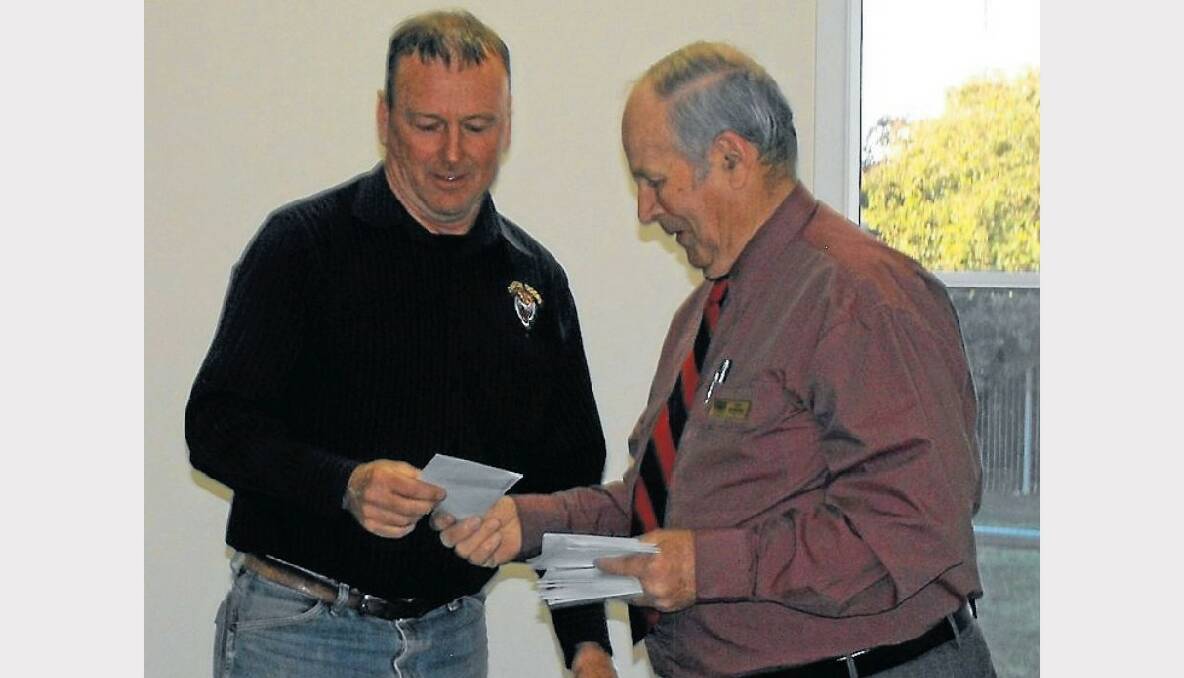 Ian Christie Johnson accepts a donation from Mayor John McMahon on behalf of the Oberon Tigers Rugby League Club.