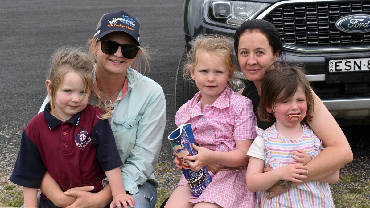 Parents Tessa Hewson and Tiffany Warburton with Poppy, Emily and an unhappy Ri-lle. Photo Peter Bowditch