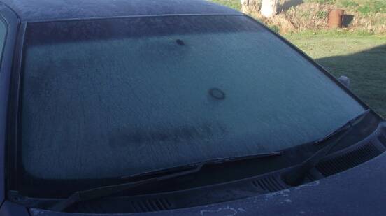 Freezing fog blanketing a car's windscreen, making it impossible to see out of. 
