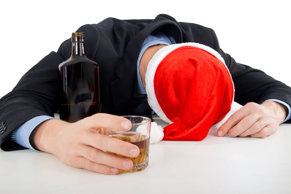 Man drinking in Santa hat at Christmas party. File Picture Man drinking in Santa hat at Christmas party. File Picture