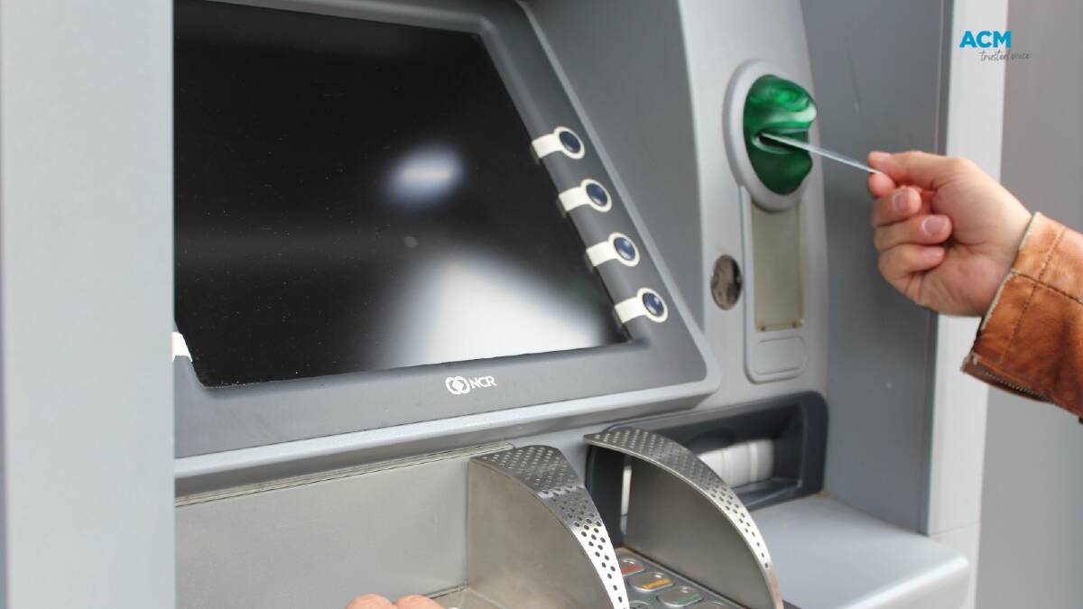 Using an ATM. Picture via Canva