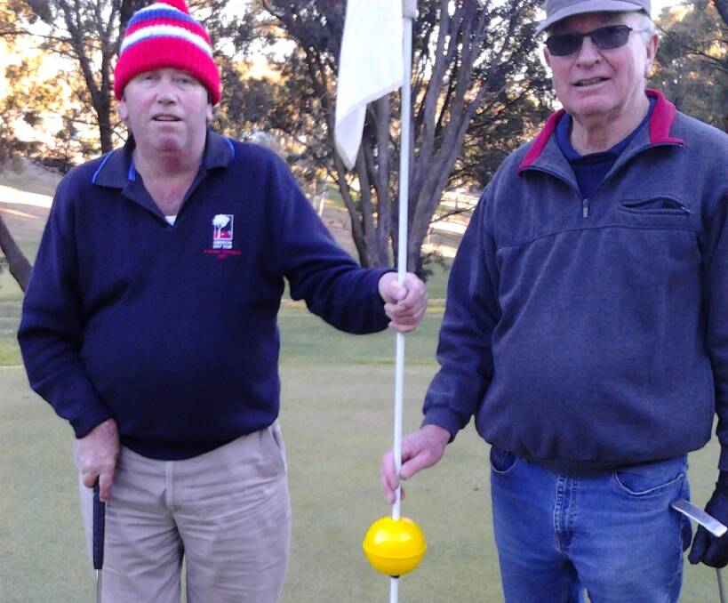 FLAG-BEARERS: Eric Whalan and Bruce Amery on the 18th hole. 
