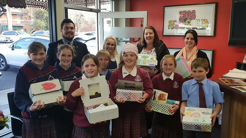 HERE TO HELP: St Joseph’s School students and teachers travelled to Bathurst recently to present donations for farmers to the 2BS radio station.
