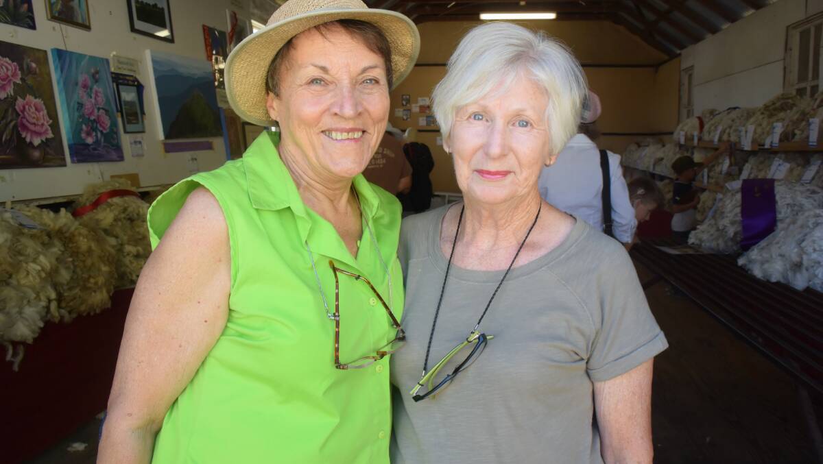 HAPPY: Show visitors Janina Knight and Bev Dale inspecting the varied pavilion displays last year.