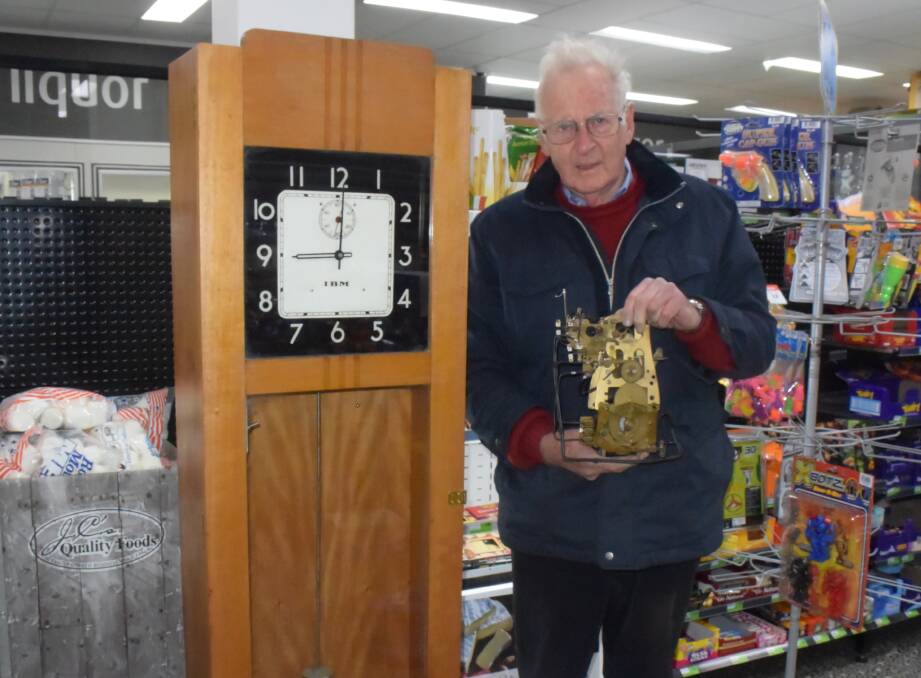 MASTERFUL: Bob Mills inside Foodworks with the master clock. A lot of time went into getting the clock going again.