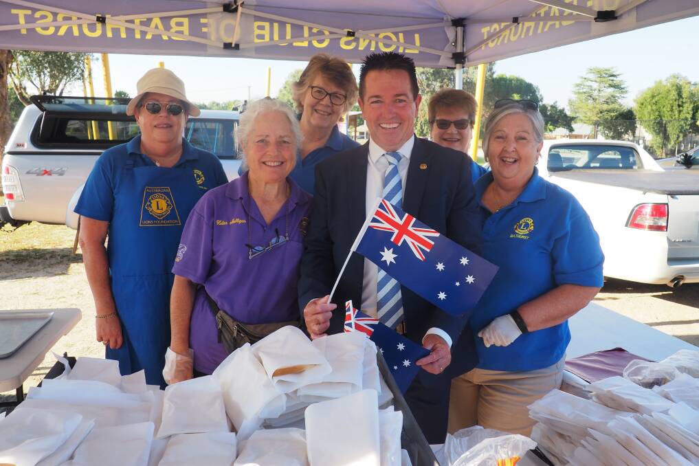 SPECIAL DAY: Member for Bathurst Paul Toole joins Lions Club volunteers to celebrate over an Aussie sausage sizzle.
