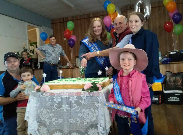 FIRST CUT: Showgirl Brooke Stanton and Clive Brabham cut the 60th anniversary cake at the Burraga Sheep Show.