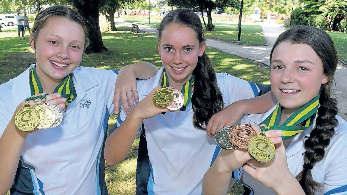 GOLDEN TIMES: Tyler Puzicha, Kalinda Robinson and Eliza Bennett display their Junior Track Nationals medals. Photo: CHRIS SEABROOK