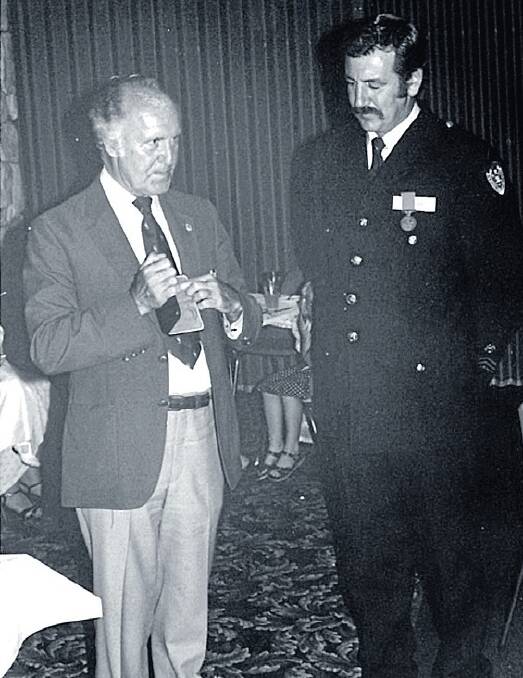 LOOKING BACK: Peter Ryan is presented with a National Service Medal in 1983 by Fire Commissioner John Down.