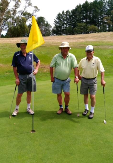 AT EASE: Kevin Whalan, Neil Whalan and Harold Lyme out on the course. The weather and the holidays attracted golfers to play.