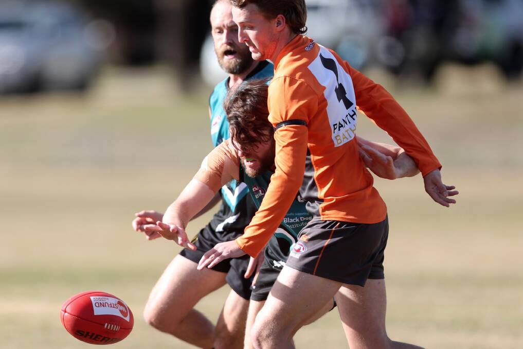 CONTESTED POSSESSION: Bathurst Bushranger Tim Hunter and Bathurst Giant Brody Tyalor compete for the Sherrin in Saturday's AFL Central West men's tier one derby. Photo: PHIL BLATCH