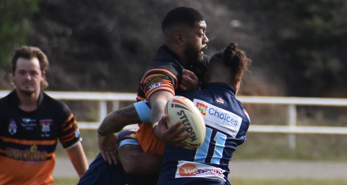 OFFLOAD: New Workies forward Tui Oloapu looks to promote the footy during his side's first-up loss to Hawks. Photo: KIRSTY HORTON