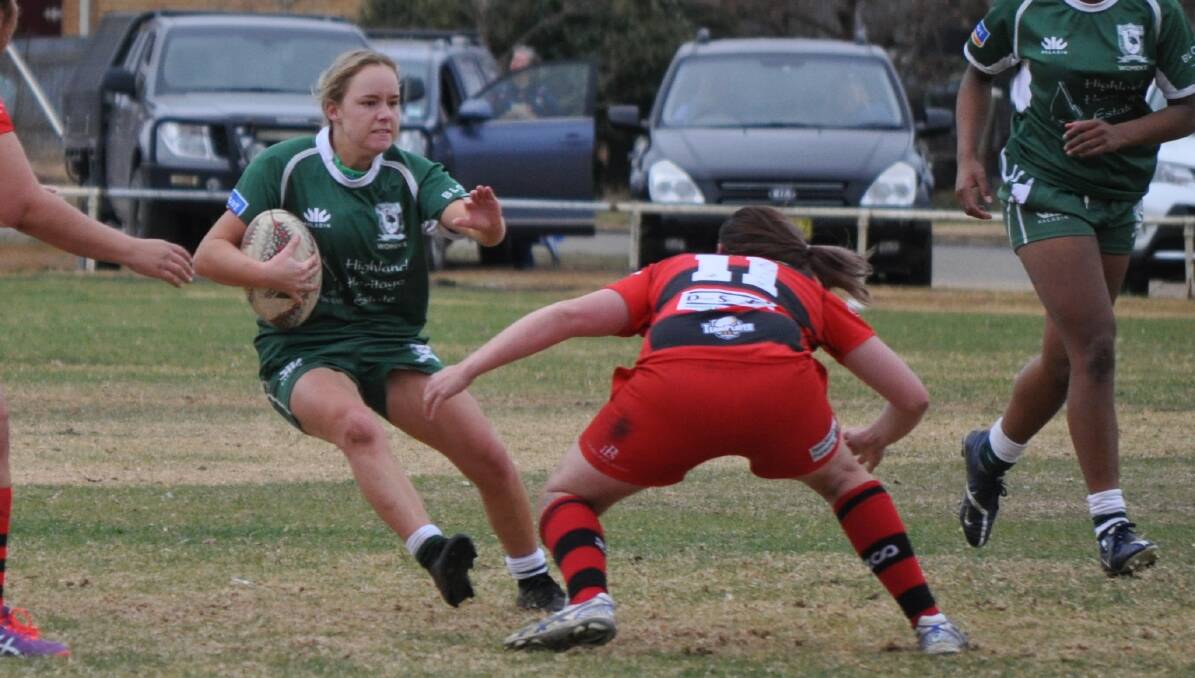 BANG: Emus halfback Emily McDonald braces for contact during her side's surprise victory over minor premiers West Wyalong last weekend in Forbes. The Ferguson Cup finals are on Saturday.