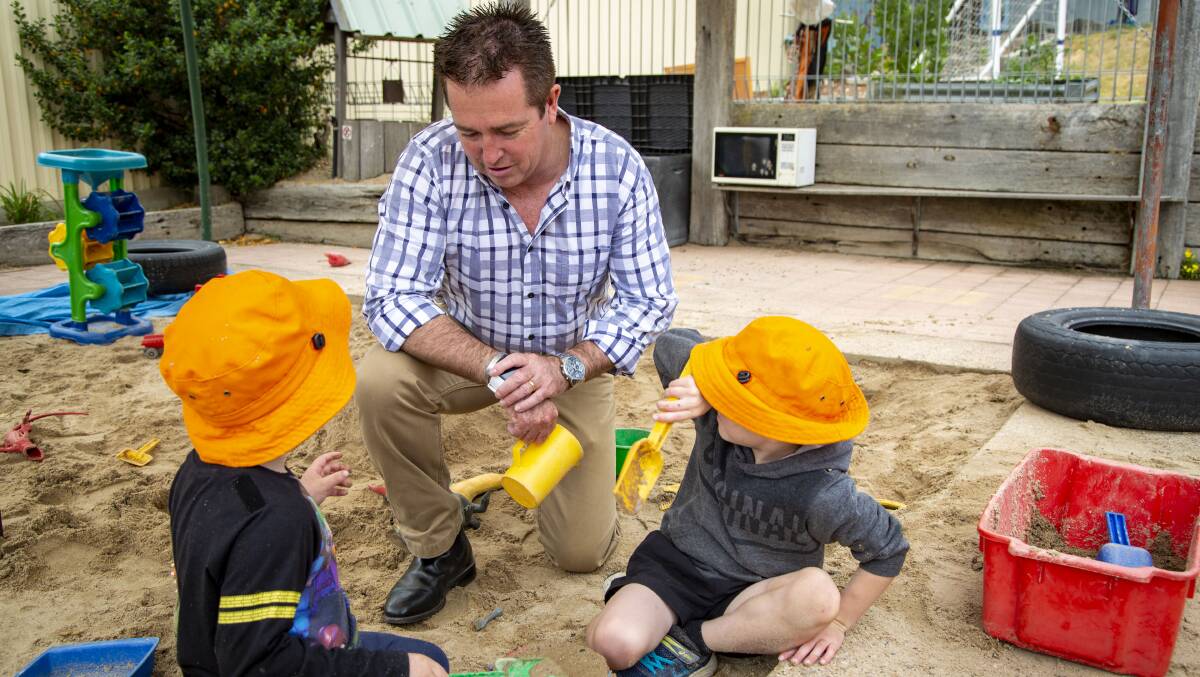 CHILD'S PLAY: Bathurst Paul MP Toole at the Oberon Childrens Centre which has received NSW Government funding of $5160 to replace worn out shade sails and give the kiddies sandpit a makeover. Photo: SUPPLIED