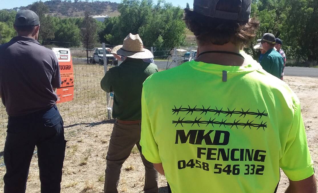 HIGH-VIS: Mitch Duffy's staff wear these high-vis work shirts with the image of two strands of HT barbed wire.