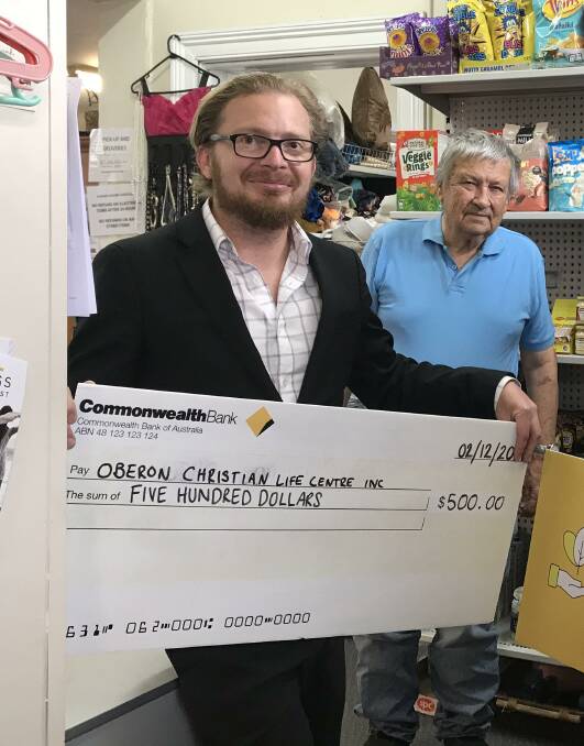 Commonwealth Bank Oberon Branch Manager Brendan Gunn with Russell Merriman, presenting the banks donation of $500 to Oberon's Christian Life Centre.