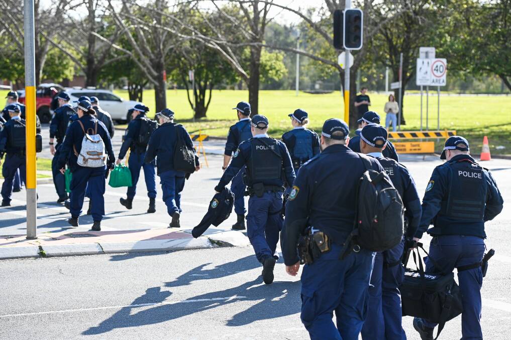 Big job: Some of the scores of police who have descended on Albury over the past four months to help patrol checkpoints along the border. Picture: MARK JESSER
