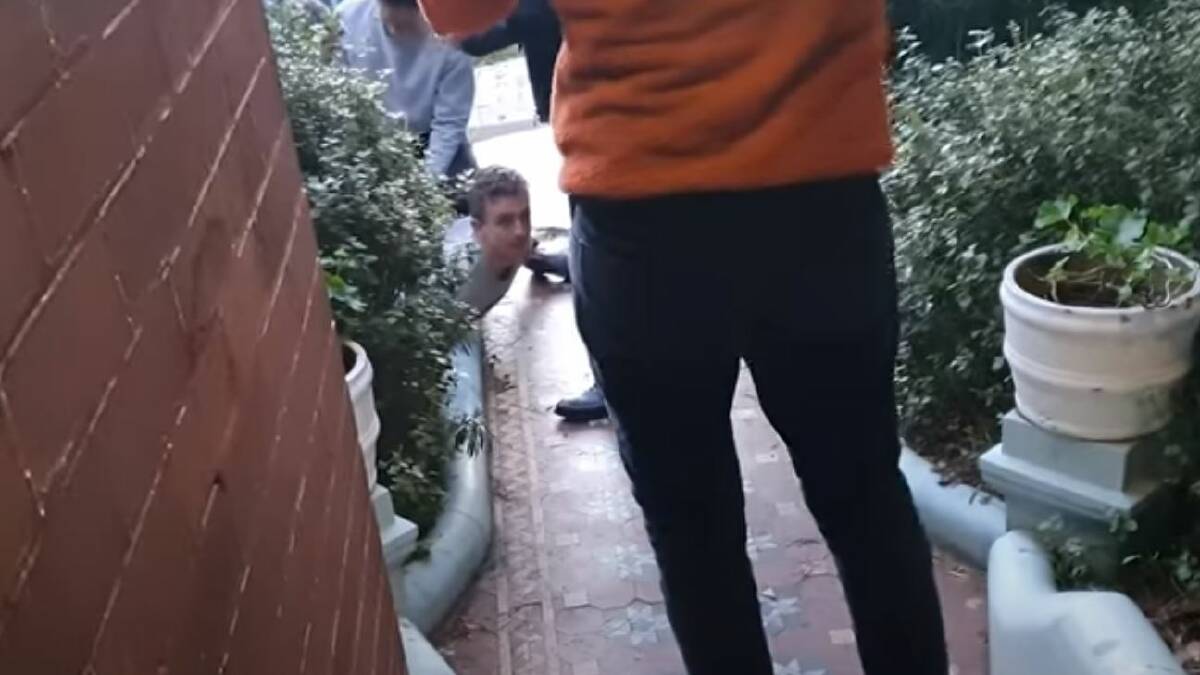 Dramatic: A still from the Friendlyjordies YouTube site showing producer Kristo Langker on the ground while being arrested at his home in Sydney.