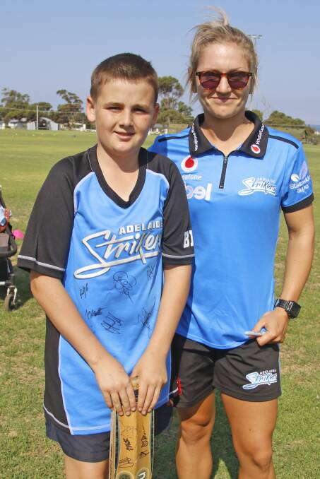 Kangaroo Island's own female cricket star Bridget Patterson with local youngster Callum Putland during the SACA bushfire tour and clinic in February. Photo Maggie Patterson