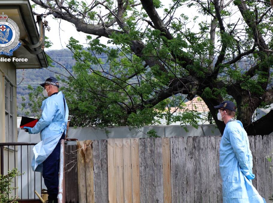 A police officer is paired with an ADF member for a recent check at a COVID-affected household in the Illawarra. Picture: NSW Police 