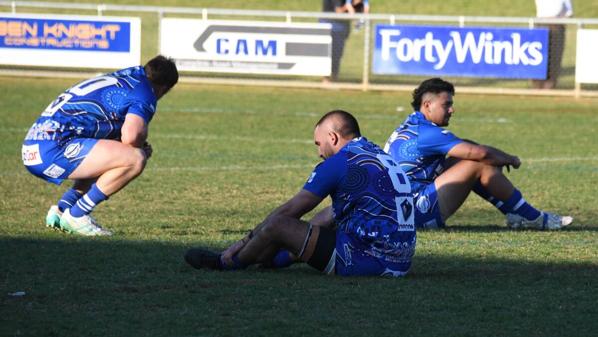 Disappointed Macquarie players at full-time at Apex Oval on Sunday. Picture by Nick Guthrie
