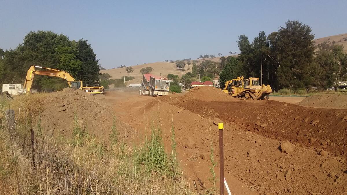 WORK IN PROGRESS: A fleet of machinery is well on the way to completing the Vale Creek levy bank at Perthville.