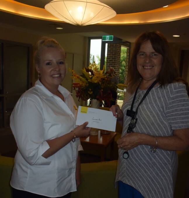 GENEROUS: Jessica Foley from Ray White Emms Mooney presents a cheque to Christine Monaghan, manager of Columbia's Aged Care facility in Oberon.