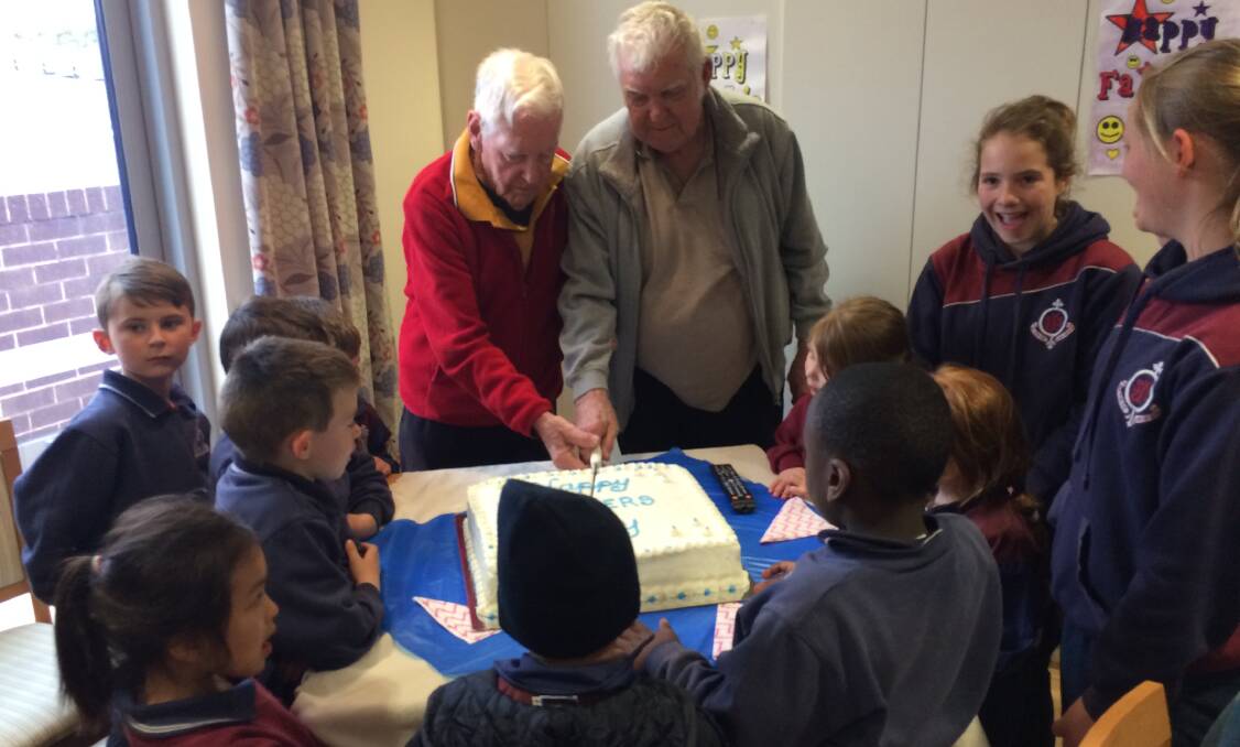 SMILE: St Joseph's School students celebrating Father's Day at Columbia Aged Care facility.