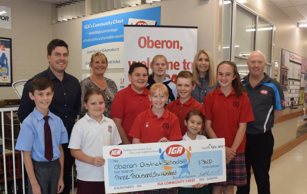 DONATIONS: Mawhood's Supa IGA and Liquor's Ian Mawhood presents local schools with Community Chest funds totalling $3600.