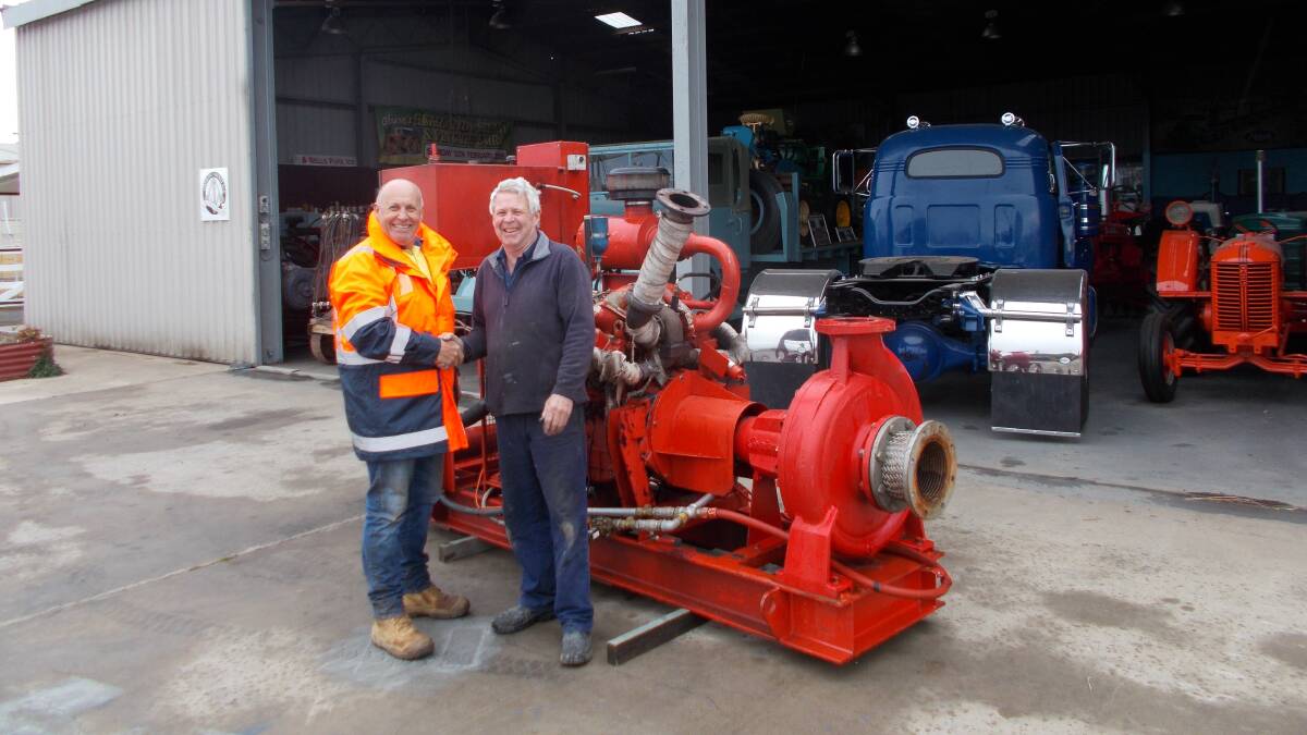 HERITAGE: Marty Gibson of Borg Construction presents a Perkins V8 diesel fire pump to add to Barry Hughes' collection.